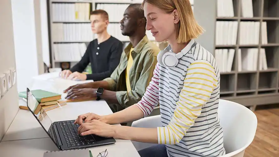 Young woman using ScreenReader on a laptop.